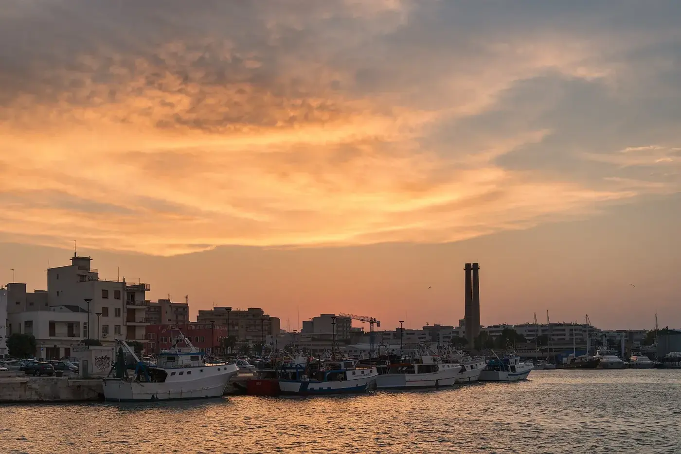 The old port of Monopoli at sunset with fishing boats